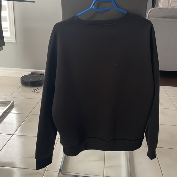 This is a black crewneck sweatshirt from shein size large US. - Picture 2 of 4